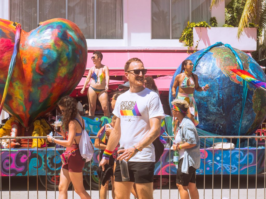 Large floats celebrating Pride drive down Ocean Drive on Sept. 19