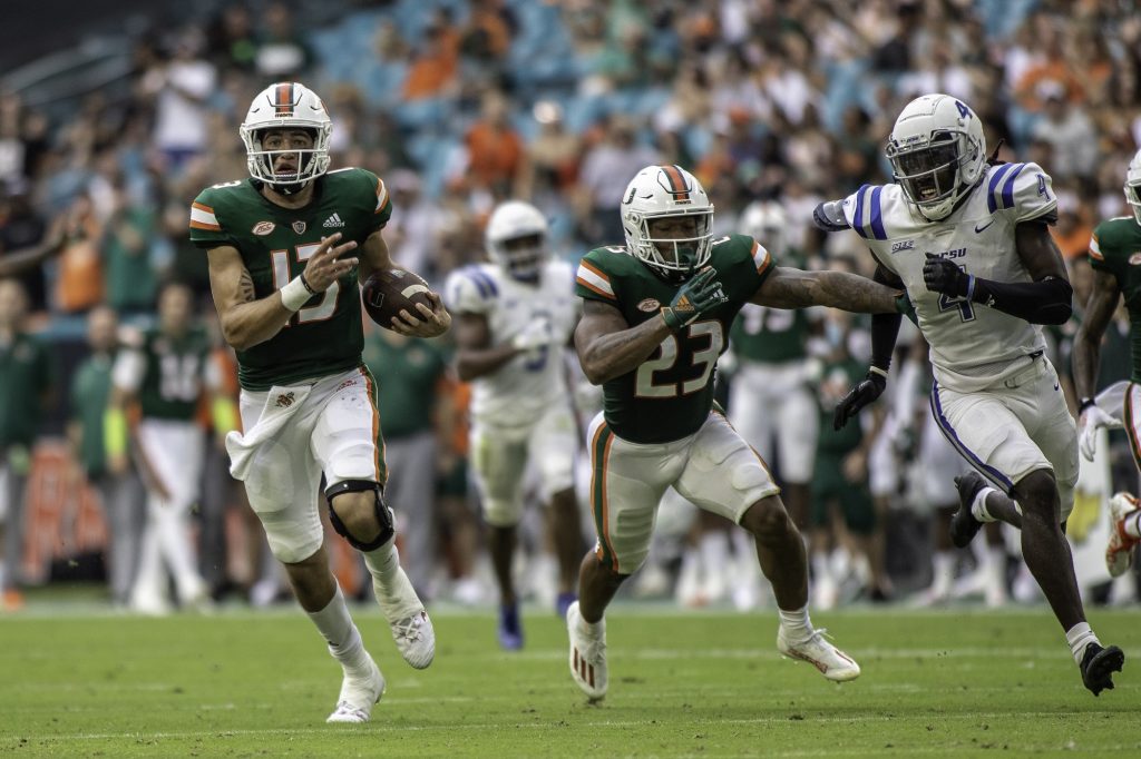 UM freshman quarterback Jake Garcia (13) escapes the pocket and runs down the field during Miami's game against Central Connecticut State on Sept. 25, 2021 at Hard Rock Stadium.