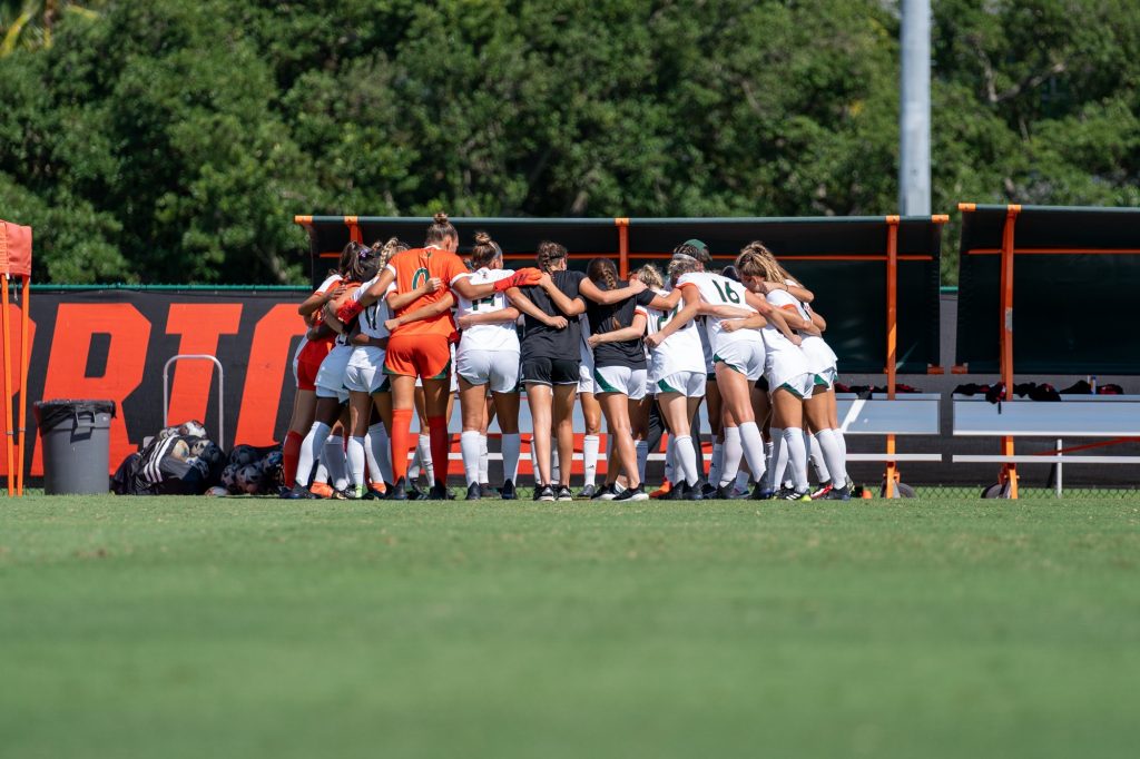 Canes soccer players huddle up before the start of their match versus Pittsburgh at Cobb Stadium on Sept. 26, 2021.