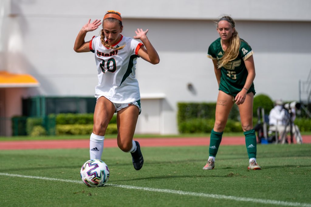 Sophomore midfielder/forward Michaela Baker indicates she was not the last to touch the ball as it heads out of bounds during the second half of the Canes’ match versus USF at Cobb Stadium on Sept. 12, 2021.