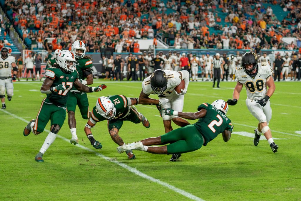Redshirt junior safety Bubba Bolden and sophomore cornerback Tyrique Stevenson try to tackle Appalachian State wide receiver Jalen Virgil during Miami's game versus Appalachian State at Hard Rock Stadium on Sept. 11, 2021.