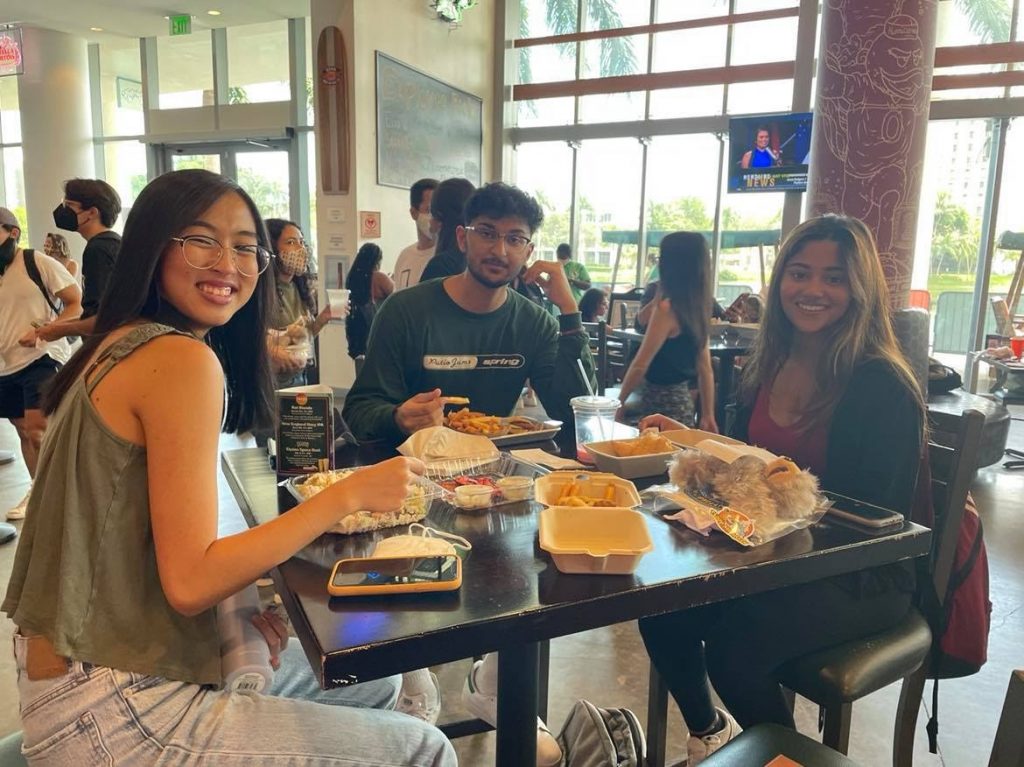 Bao Duong, Ishaan Shah and Amrutha Chethikattil enjoy their food and stuffed plushies at The Rat on Wednesday, Sept. 8. After a year of strict COVID-19 regulations, students anticipate a slow return to normality at the campus institution.