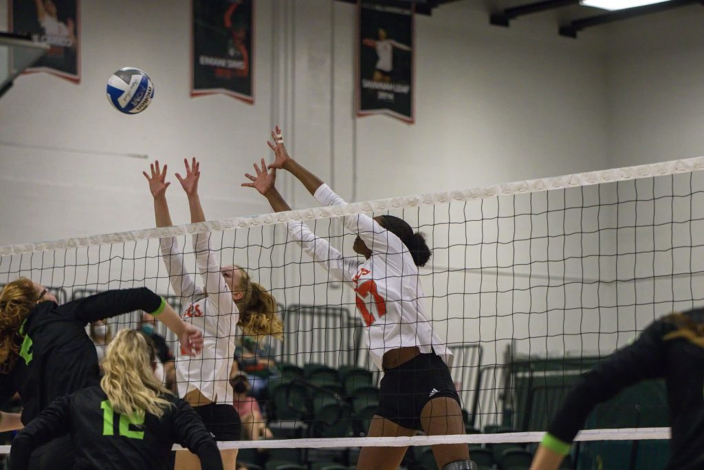 Juniors Janice Leao and Savannah Vach block the ball during Miami’s game against USF in the Knight Sports Complex on Sept. 5, 2021.