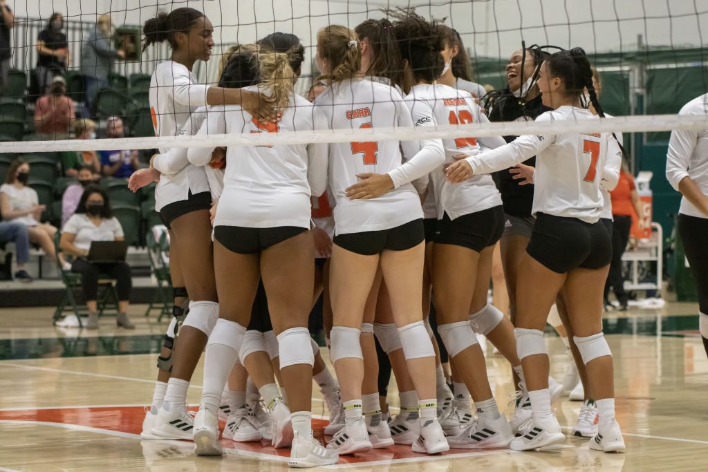 The University of Miami women's volleyball team celebrates after winning a point during their match against USF on Sept. 5, 2021 at the Knight Sports Complex in Coral Gables, Fl.