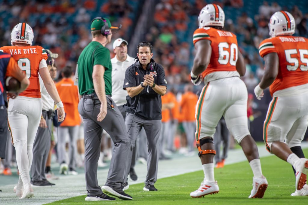 Head coach Manny Diaz encourages players as they leave the field after an offensive drive. Miami lost to Virginia 30-28 after a missed field goal attempt in the final seconds of the game at Hard Rock Stadium on Thursday Sept. 30.