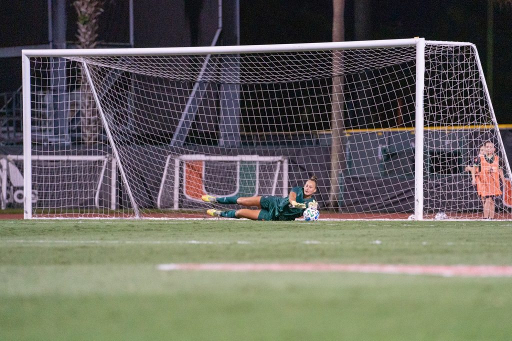 Junior goalkeeper Melissa Dagenais dives to make a save during the first half of Miami’s match versus Clemson at Cobb Stadium on Oct. 16, 2021. Dagenais had 7 saves in the Canes' 0-1 loss.