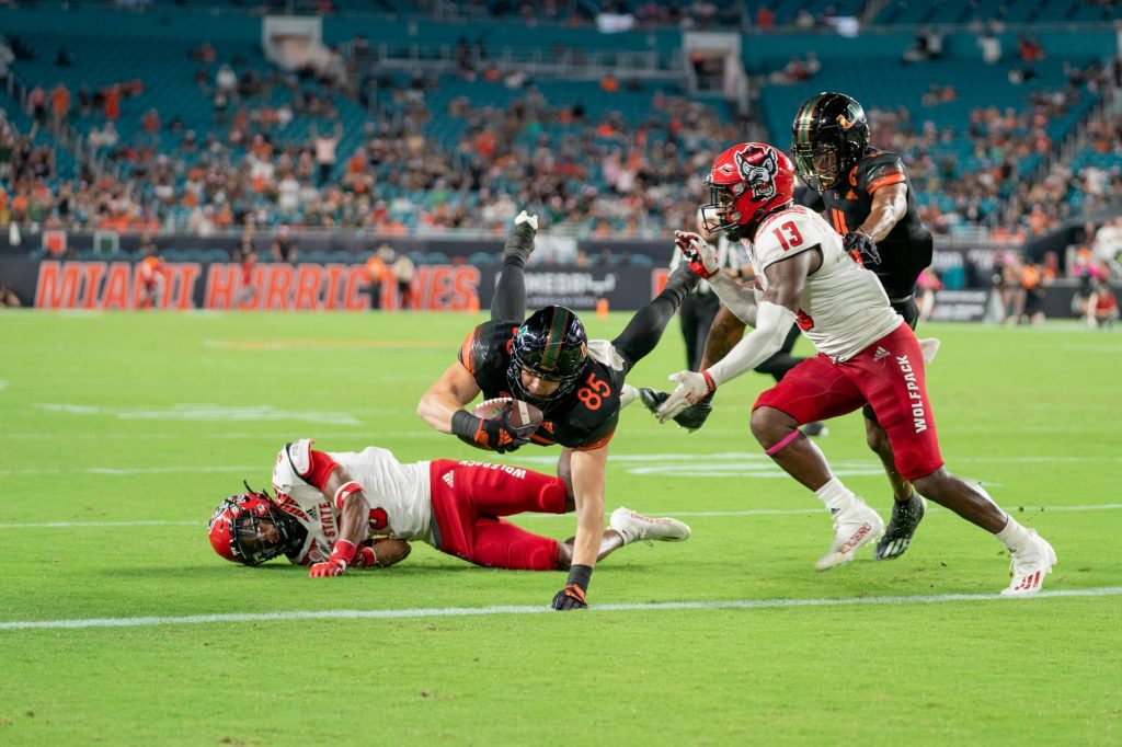 Junior tight end Will Mallory dives into the end zone, scoring a touchdown in the third quarter of Miami’s game versus NC State University at Hard Rock Stadium on Oct. 23, 2021.