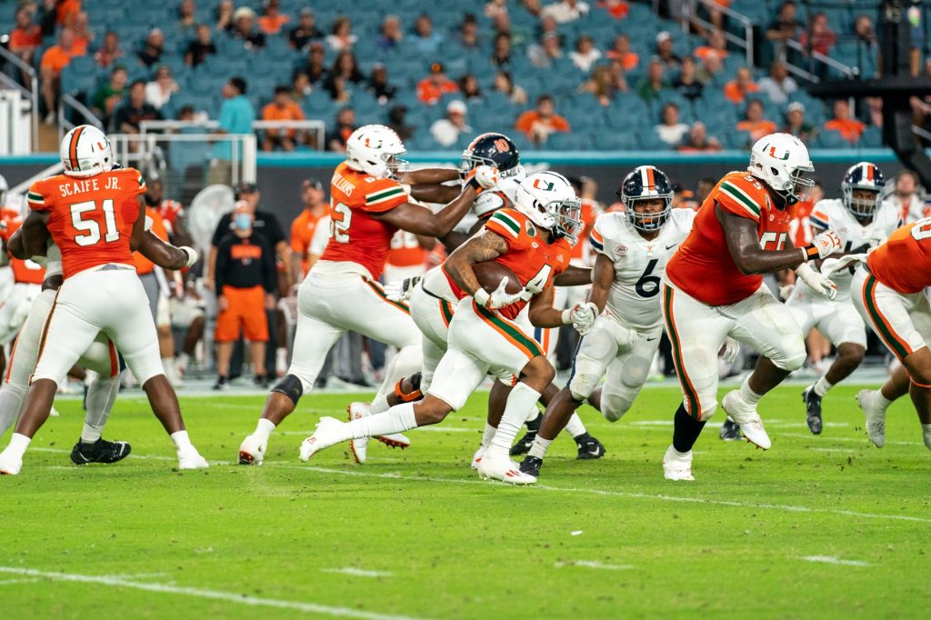 Freshman running back Jaylan Knighton rushes downfield with the ball during the third quarter of Miami’s game versus the University of Virginia at Hard Rock Stadium on Sept. 30, 2021. Knighton had 15 carries, totaling 44 yards.
