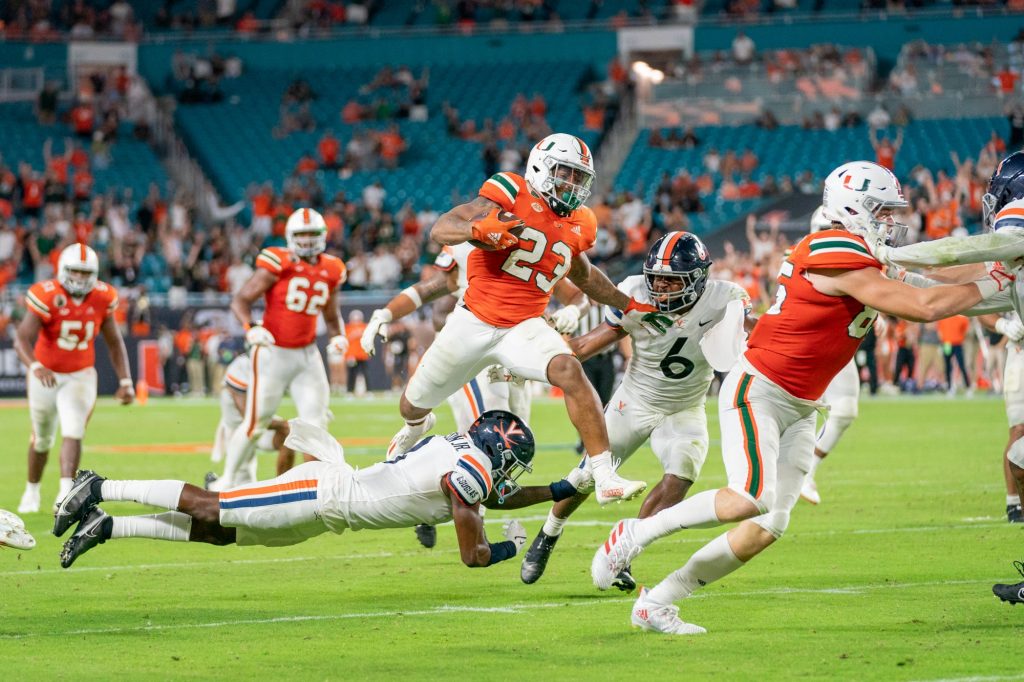Junior running back Cam’Ron Harris leaps over a Virginia defender during the fourth quarter of Miami’s game versus the University of Virginia at Hard Rock Stadium on Sept. 30, 2021. Harris had 14 carries for 111 yards and two touchdowns.