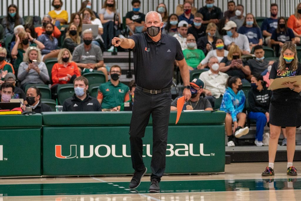 Head coach Jose "Keno" Gandara points something out to his players during the first set of Miami’s match versus the University of North Carolina  in the Knight Sports Complex on Oct. 1, 2021.
