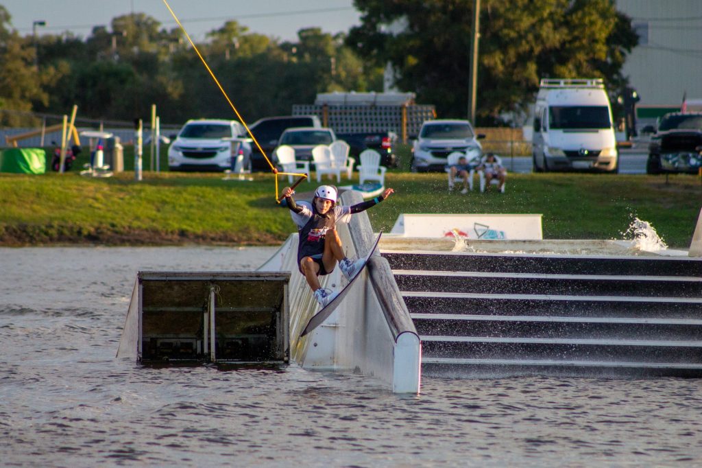Freshman Daniela Abuchaibe attempts a boardslide down the railing at the Redbull Rivals Wakeboarding competition in Orlando, Fl. Abuchaibe competed in both the Big Air Kicker Competition and the Rail Jam Competition.