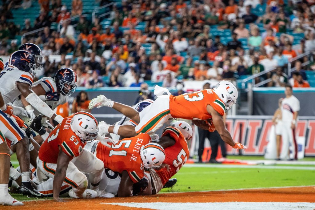 Running back Cam'Ron Harris leaps over the pile to score a touchdown against Virginia on Sept. 30, 2021 at Hard Rock Stadium.