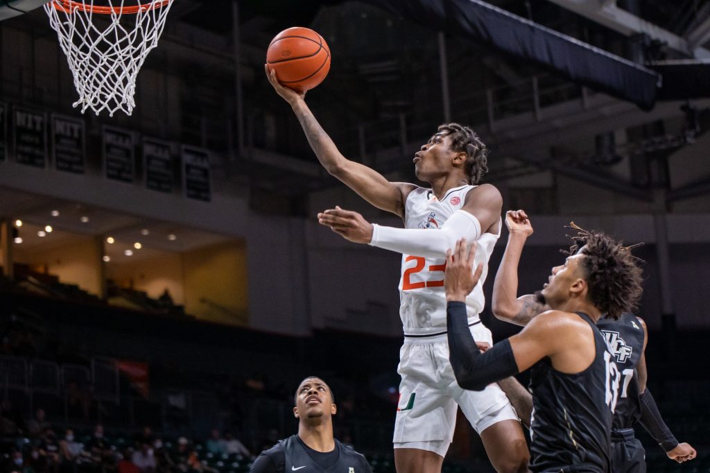 Sixth-year redshirt senior Kameron McGusty goes up for a shot after getting past two UCF defenders in Miami’s loss on Saturday, Nov. 14 at the Watsco Center. Even with McGusty’s game-high 28 points, Miami was unable to secure a victory in its second game of the season.