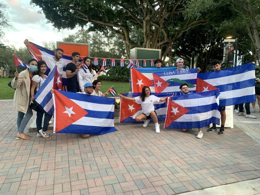 UM students wave Cuban flags and at the U statue in solidarity with the political prisoners held in Cuba on Monday, Nov. 15.