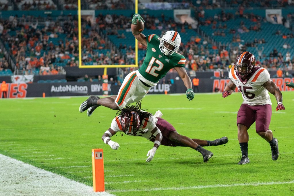 Freshman wide receiver Brashard Smith attempts to hurdle a defender during the second quarter of Miami’s game versus Virginia Tech at Hard Rock Stadium on Nov. 20, 2021.