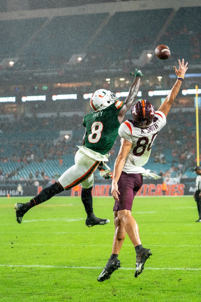 Junior cornerback DJ Ivey and Virginia Tech wide receiver Christian Moss reach out in an attempt to catch an end zone pass during the third quarter of Miami’s game versus Virginia Tech at Hard Rock Stadium on Nov. 20, 2021. The pass was incomplete.