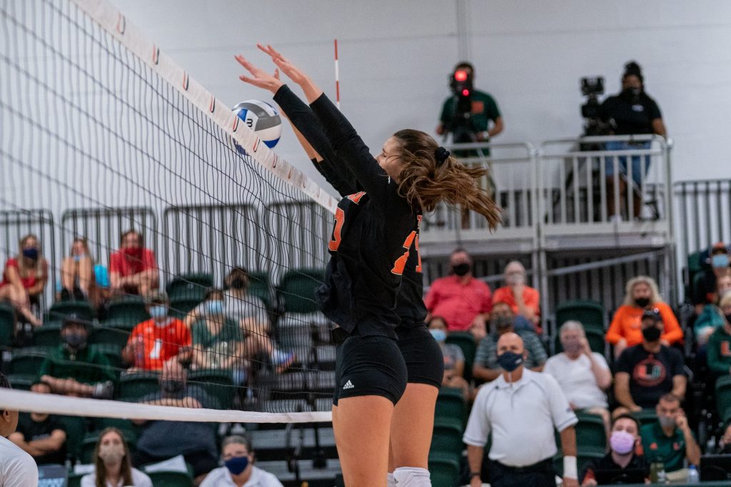 Graduate student middle blocker Aristea Tontai and freshman outside hitter Peyman Yardimci block a Boston College shot during the first set of Miami’s match versus Boston College in the Knight Sports Complex on Oct. 31, 2021.
