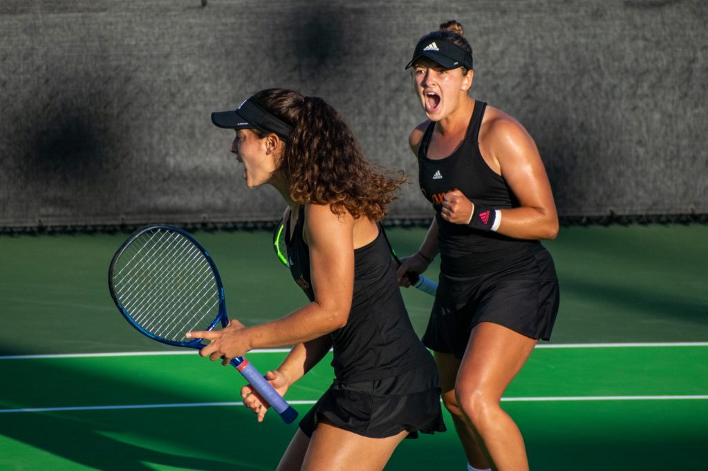 Third-year sophomores Diana Khodan and Maya Tahan celebrate a point during their doubles match against Georgia Tech on Friday, February 25, 2022 at the Neil Schiff Tennis Center.