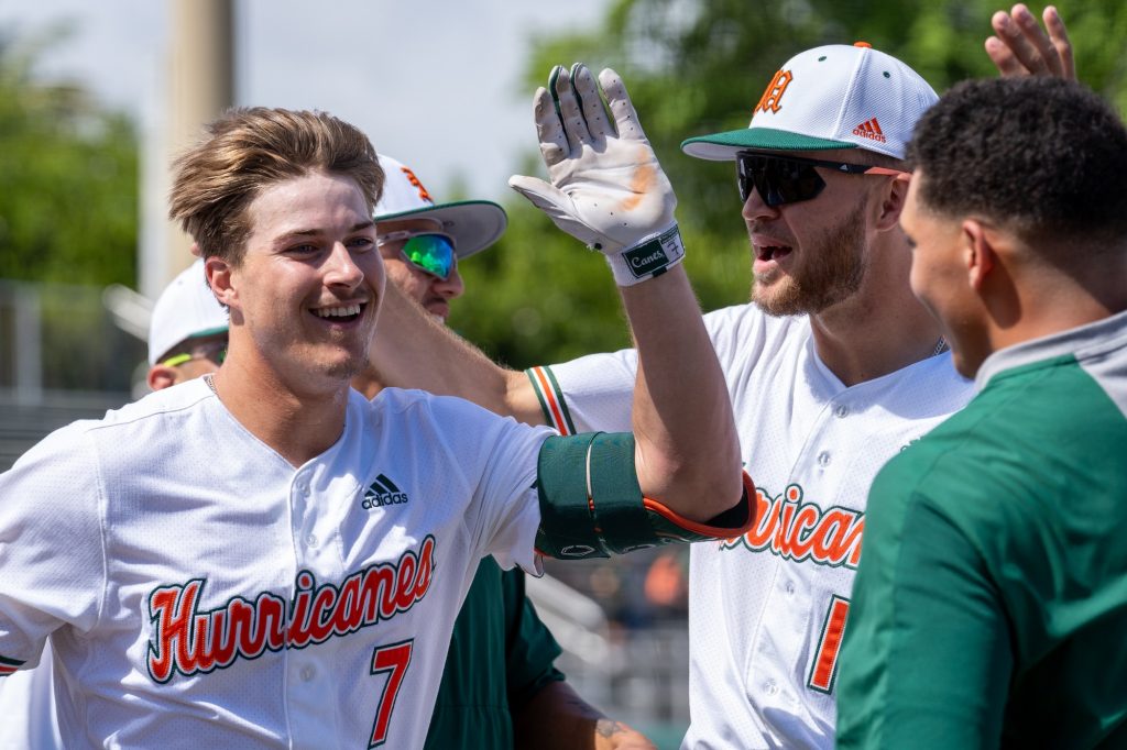 Sophomore outfielder Jacob Burke celebrates with teammates as he heads for the dugout after hitting a three-run home run in the bottom of the first inning of Miami’s game versus Harvard at Mark Light Field on Feb. 27, 2022.