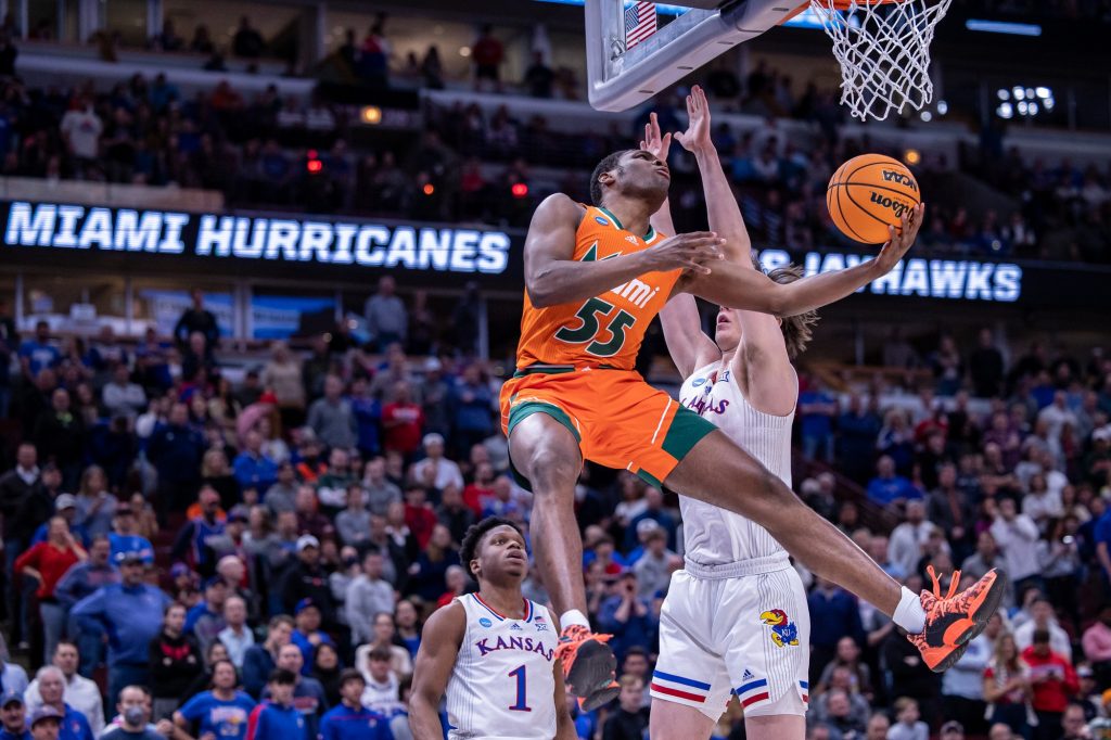 Freshman Wooga Poplar attempts a shot from underneath the basket during the second half of Miami's loss to Kansas in the Elite Eight at the United Center in Chicago on Sunday, March 27, 2022.
