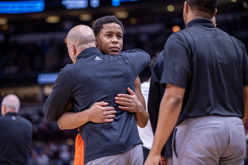 Sixth-year senior guard Charlie Moore embraces associate head coach Chris Caputo in Miami's 76-50 loss to top-seeded Kansas in the Elite Eight on Sunday, March 27, 2022 at the United Center.