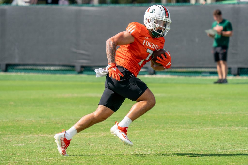 Third-year sophomore wide receiver Xavier Restrepo runs after catching a ball during drills at the Greentree Practice Fields on March 11, 2022.
