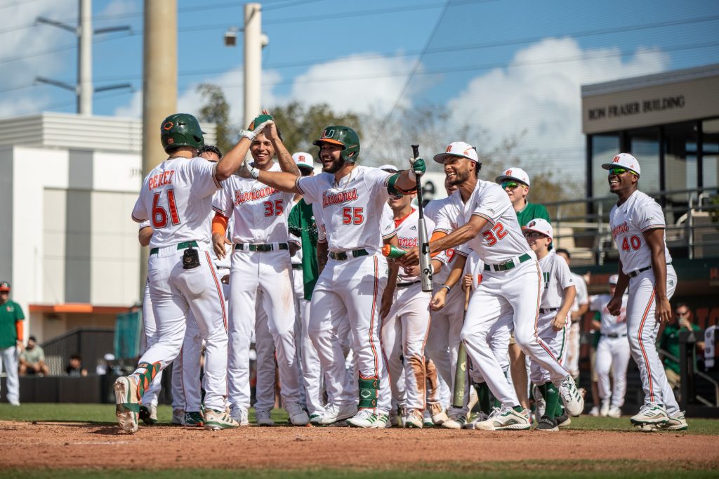 Player celebrate with sophomore catcher Carlos Perez as he hits his first home run of the season in Miami's dominant 10-0 win over Harvard Sunday, Feb. 28, 2022 at Mark Light Field.