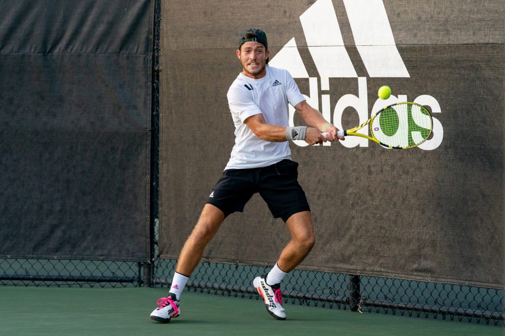 Fourth-year junior Oren Vassler returns the ball during the third game of the first set of his singles match versus senior Henry Lieberman at the Neil Schiff Tennis Center on March 11, 2022.