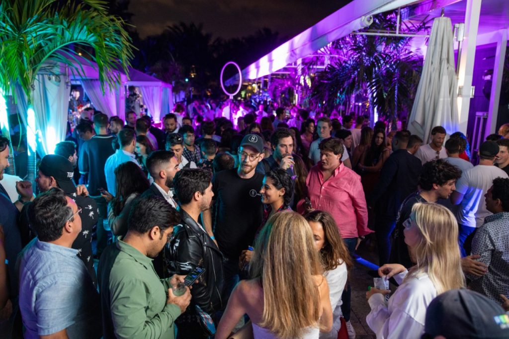 Partygoers network while enjoying an open bar and buffet.