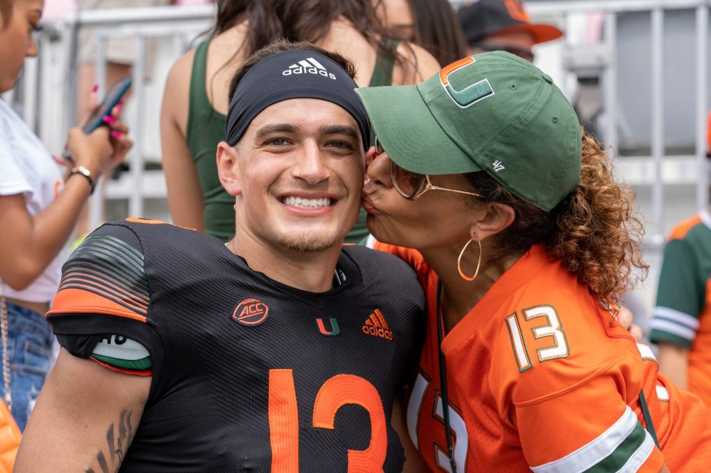 Redshirt freshman quarterback Jake Garcia poses with mother Yvonne Garcia at the conclusion of Miami's Spring Game at DRV PNK Stadium on April 16, 2022.