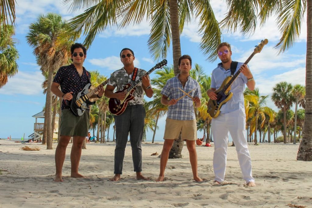 Frost band Pump Action poses with their instruments for promotional pictures on the beach in Miami.