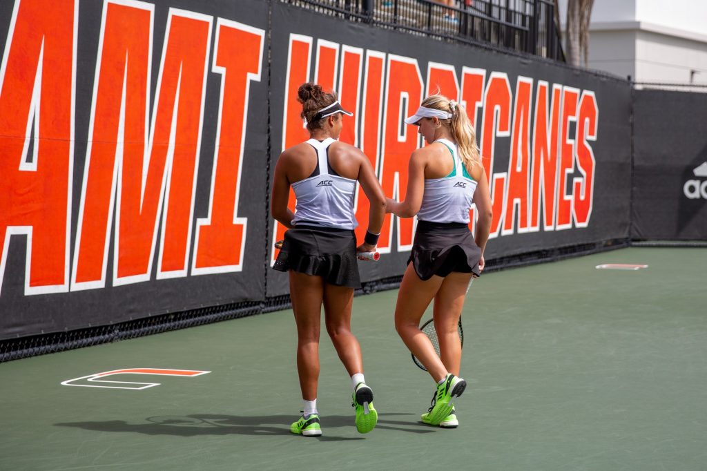 Fourth-year junior Daevenia Achong and fifth-year senior Eden Richardson chat during their doubles match against UCF on February 20.