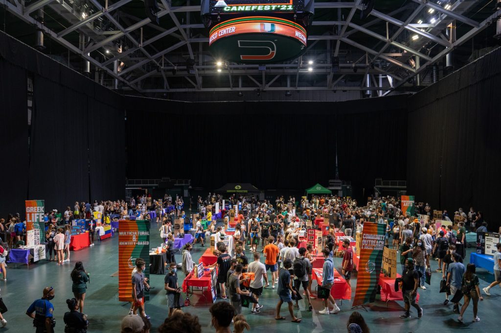 Students walk through rows of booths showcasing a portion of the 300+ student organizations and departments at Canefest 2021 in the Watsco Center, on Aug. 22, 2021.