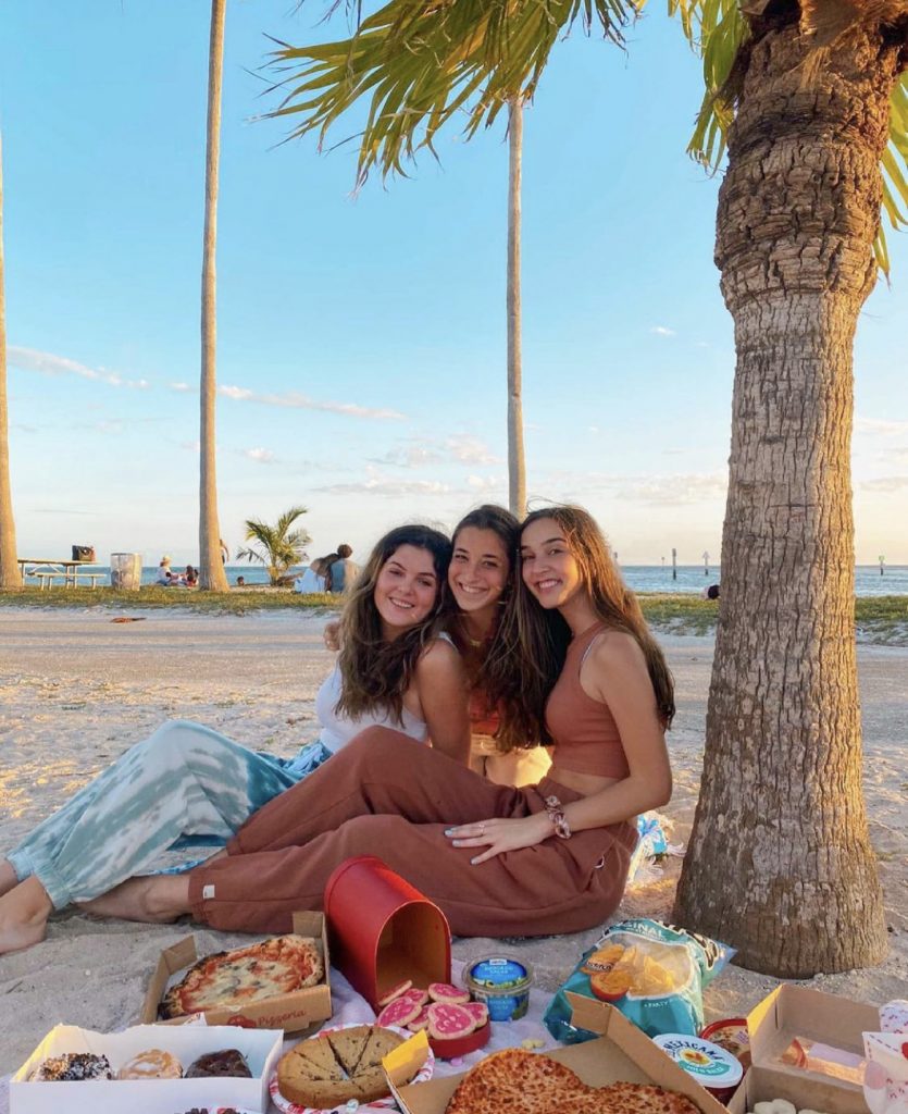 UM studnets, Emma Mckeon, Olivia Cole and Annalise Scorzari, pose for a photo during a picnic at Matheson Hammock Beach on Feb 14, 2021.