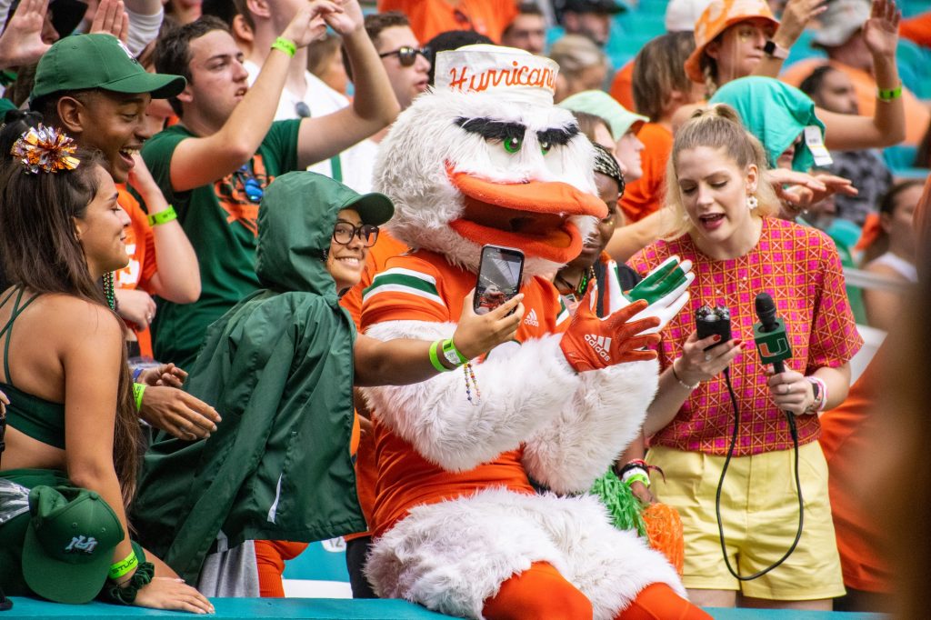 Students pose with Sebastian during Miami's game against Middle Tennessee State University on Sept. 24, 2022 at Hard Rock Stadium.