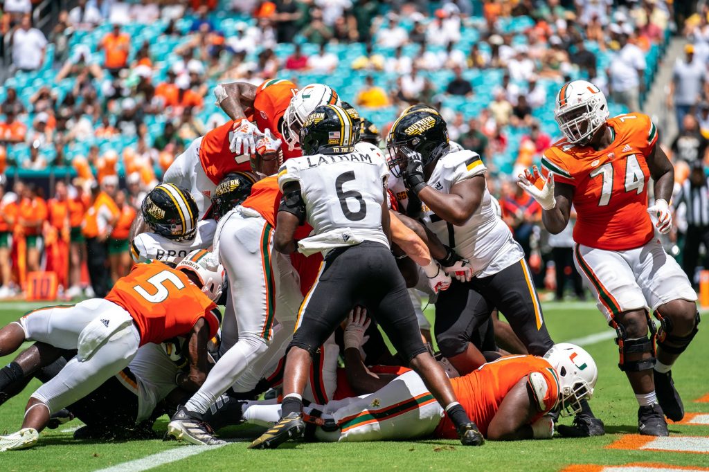Third-year sophomore running back Henry Parrish, Jr. leaps atop the pile at the goal line to score a touchdown in the second quarter of Miami’s game versus the University of Southern Mississippi at Hard Rock Stadium on Sept. 10, 2022.