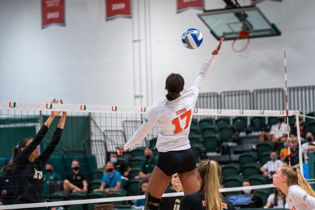 Junior middle blocker Janice Leao tips the ball during the Canes’ game versus UMBC in the Knight Sports Complex on Aug. 29, 2021.