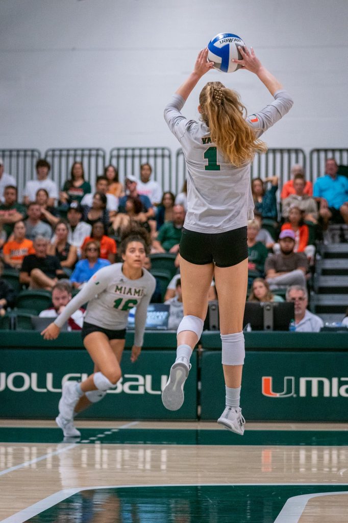 Senior setter Savannah Vach sets the ball to sophomore outside hitter Nyah Anderson during the second set of Miami’s match versus the University of South Carolina in the Knight Sports Complex on Sept. 16, 2022.