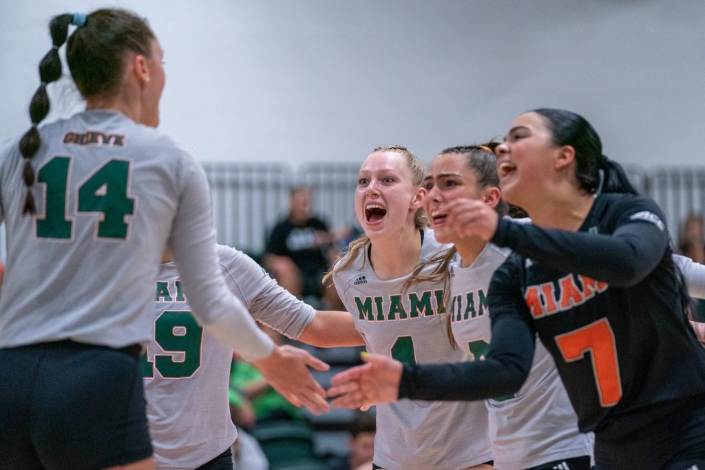 ‘Canes volleyball players celebrate winning a point during the third set of their match versus the University of South Carolina in the Knight Sports Complex on Sept. 16, 2022.