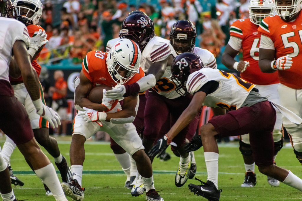 Running Back Terrell Walden II brushes off defenders during Miami's 70-13 win over Bethune-Cookman on Sept. 3 at Hard Rock Stadium.