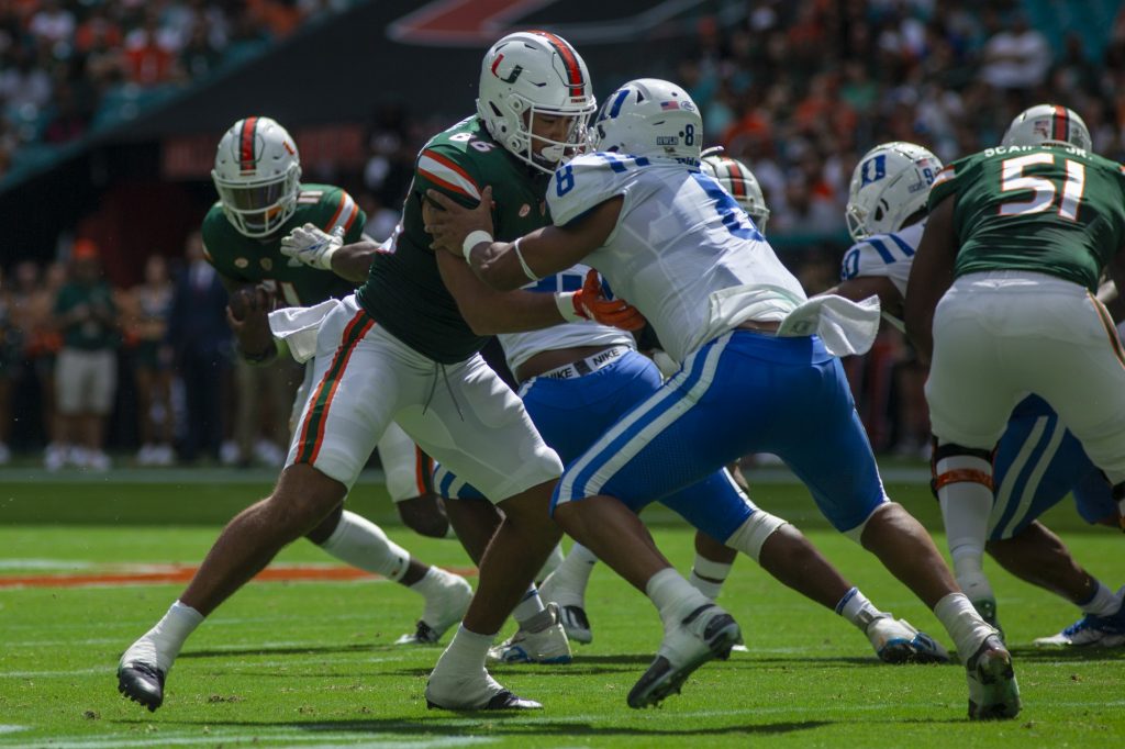 Third-year redshirt freshman tight end Dominic Mammarelli goes head to head with a Duke player during Miami's game against the Blue Devils on Saturday, Oct. 22 at Hard Rock Stadium.