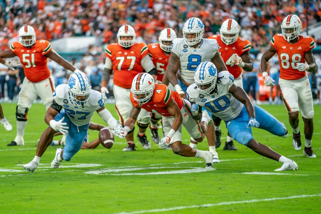 Third-year sophomore running back Jaylan Knighton scrambles to the ball in an attempt to recover his fumble during the fourth quarter of Miami’s game versus the University of North Carolina at Hard Rock Stadium on Oct. 8, 2022. The Tar Heels recovered the ball.