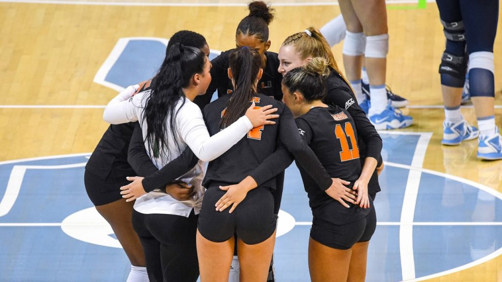 Miami volleyball players talk strategy in its match against North Carolina on September 30, 2022.