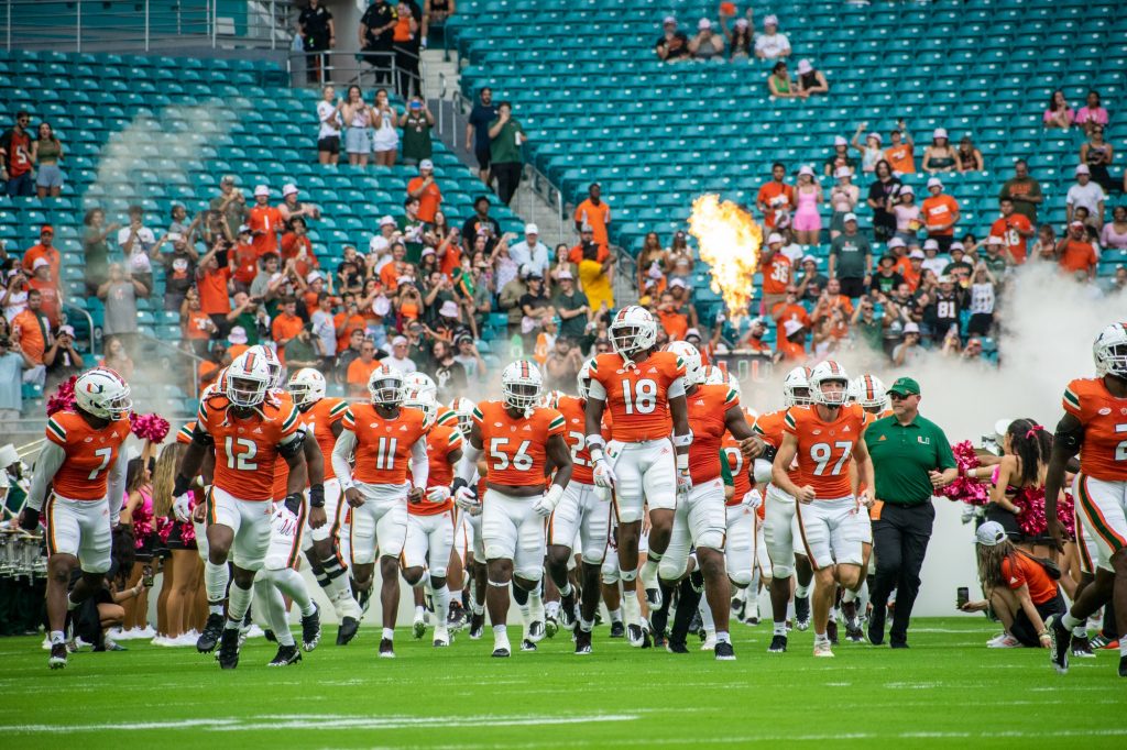 Players run onto the field to start Miami's game against the University of North Carolina on Saturday, Oct. 8 at Hard Rock Stadium.