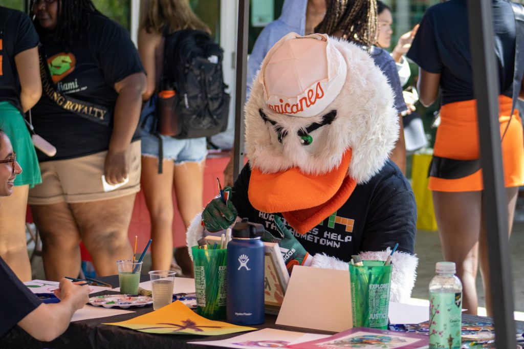 Sebastian the Ibis sits and paints with students in support of the Art For Kids booth at the Hurricanes Help the Hometown event on Nov 2 at the Lakeside Patio.