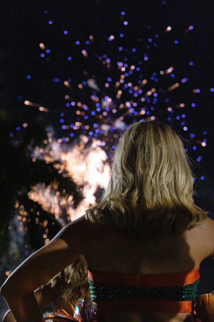A Hurricanette dancer stands and admires the fireworks during Miami's annual Hurricane Howl on Nov. 4 around Lake Osceola.