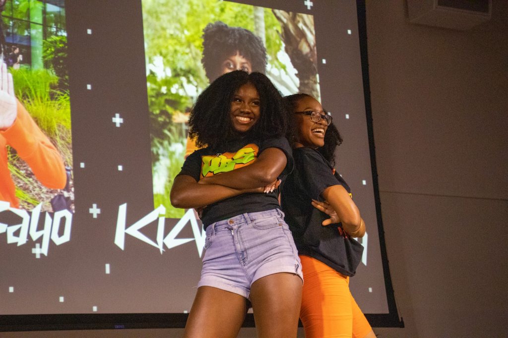 Contestants Hula Bayo and Kianna Dorsey pose together after they finish their skit at the Royalty Pageant on Nov. 1 in the Shalala Student Center Ballroom.