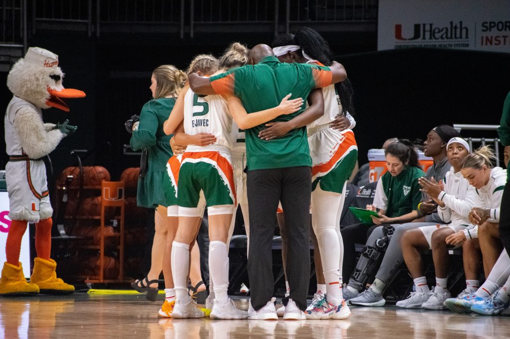 Miami starters huddle with assisstant coach Fitzroy Anthony prior to Miami's game against UMES on Monday, Nov. 7 at the Watsco Center.
