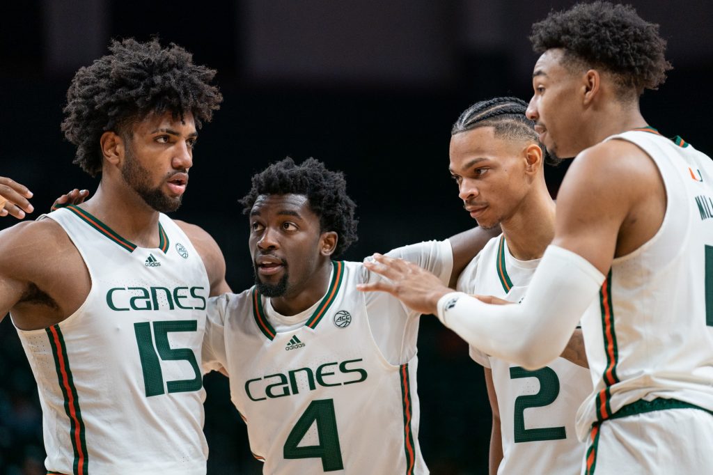 ‘Canes players discuss their game plan before free throws during the second half of Miami’s game versus St. Francis University in the Watsco Center on Dec. 17, 2022.