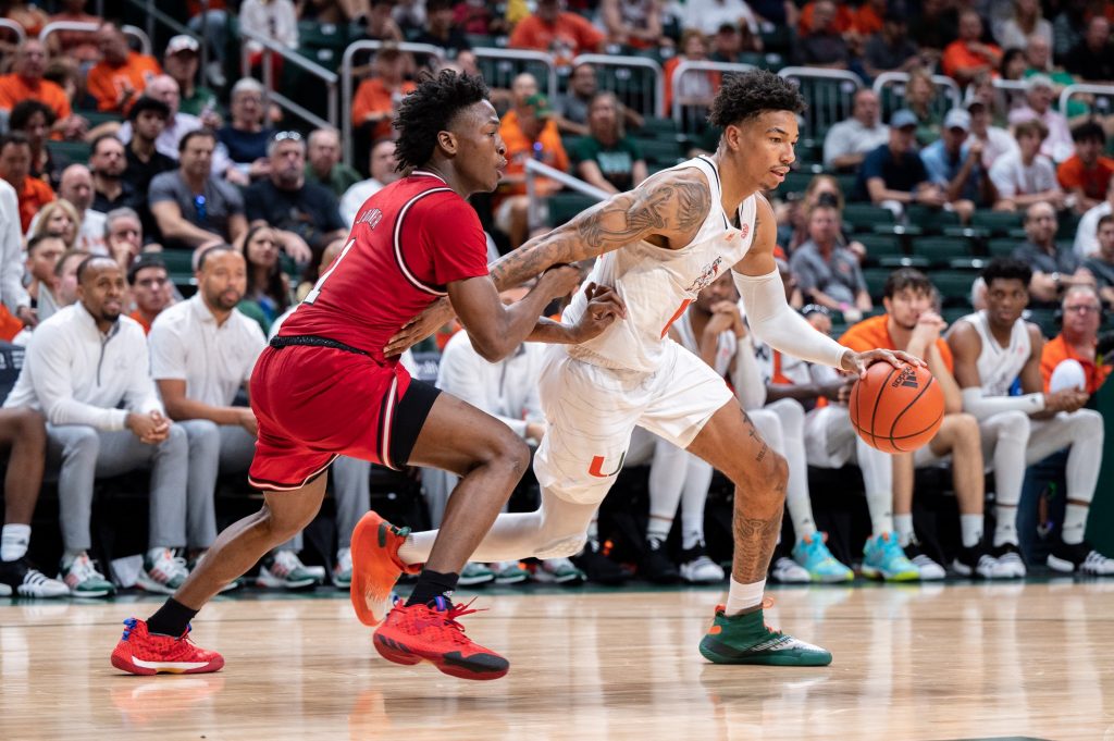 Fifth-year senior guard Jordan Miller drives to the basket during Miami's game against North Carolina State on Saturday, Dec. 10 at the Watsco Center.